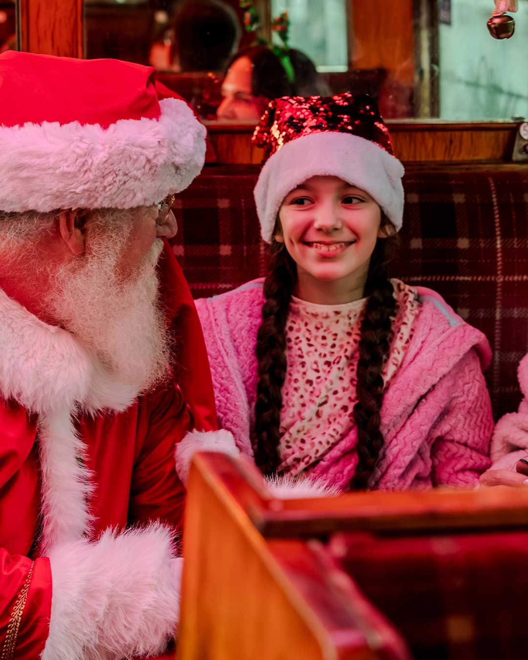 santa and children on board the polar express train ride