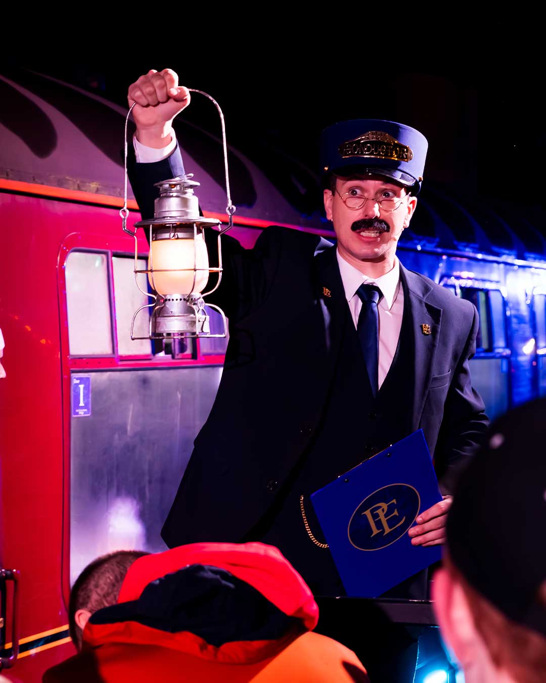 conductor with lantern at the polar express train ride
