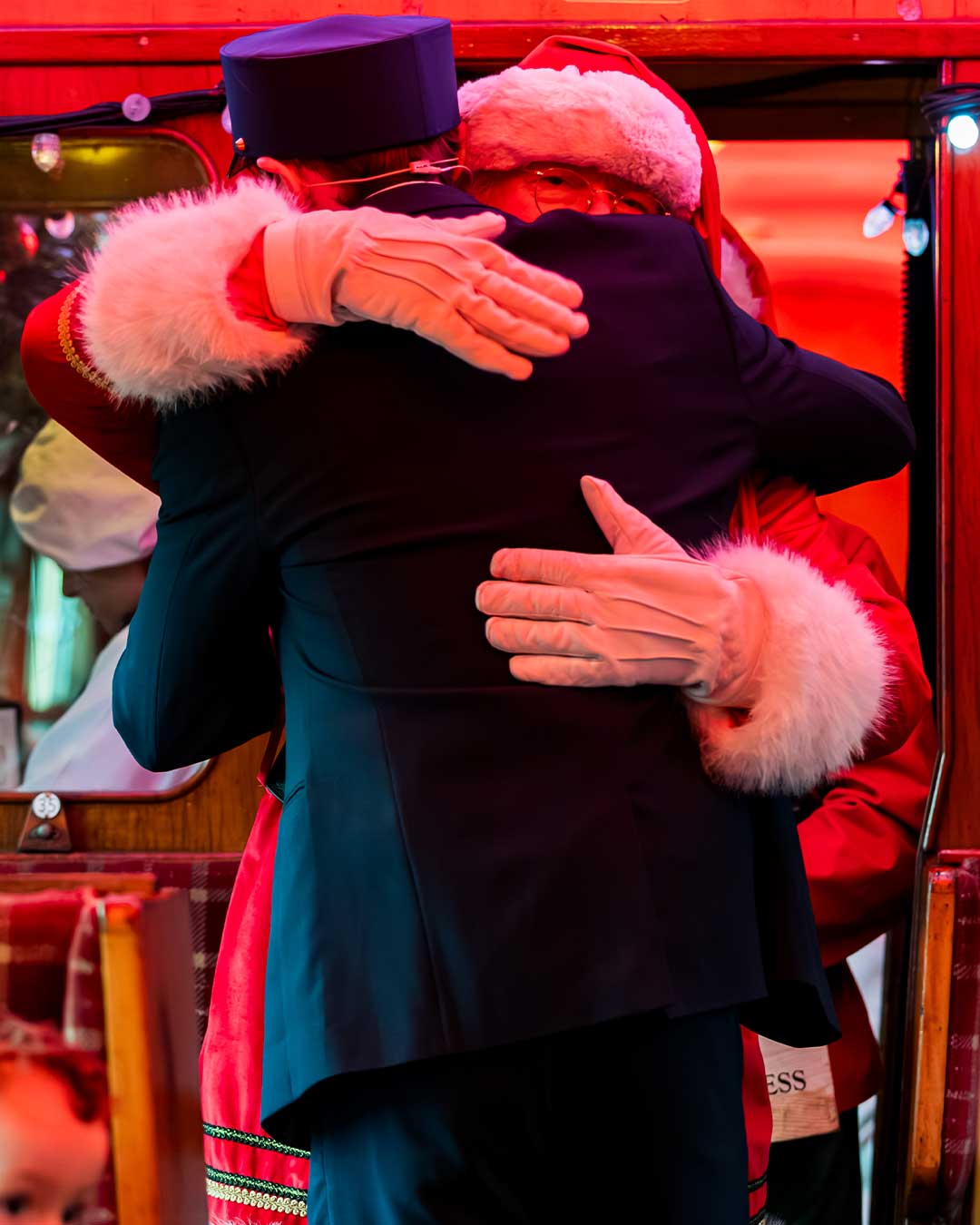 santa and conductor on board the polar express train ride