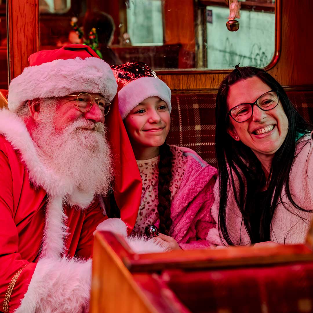 santa taking a photo on board the polar express train ride
